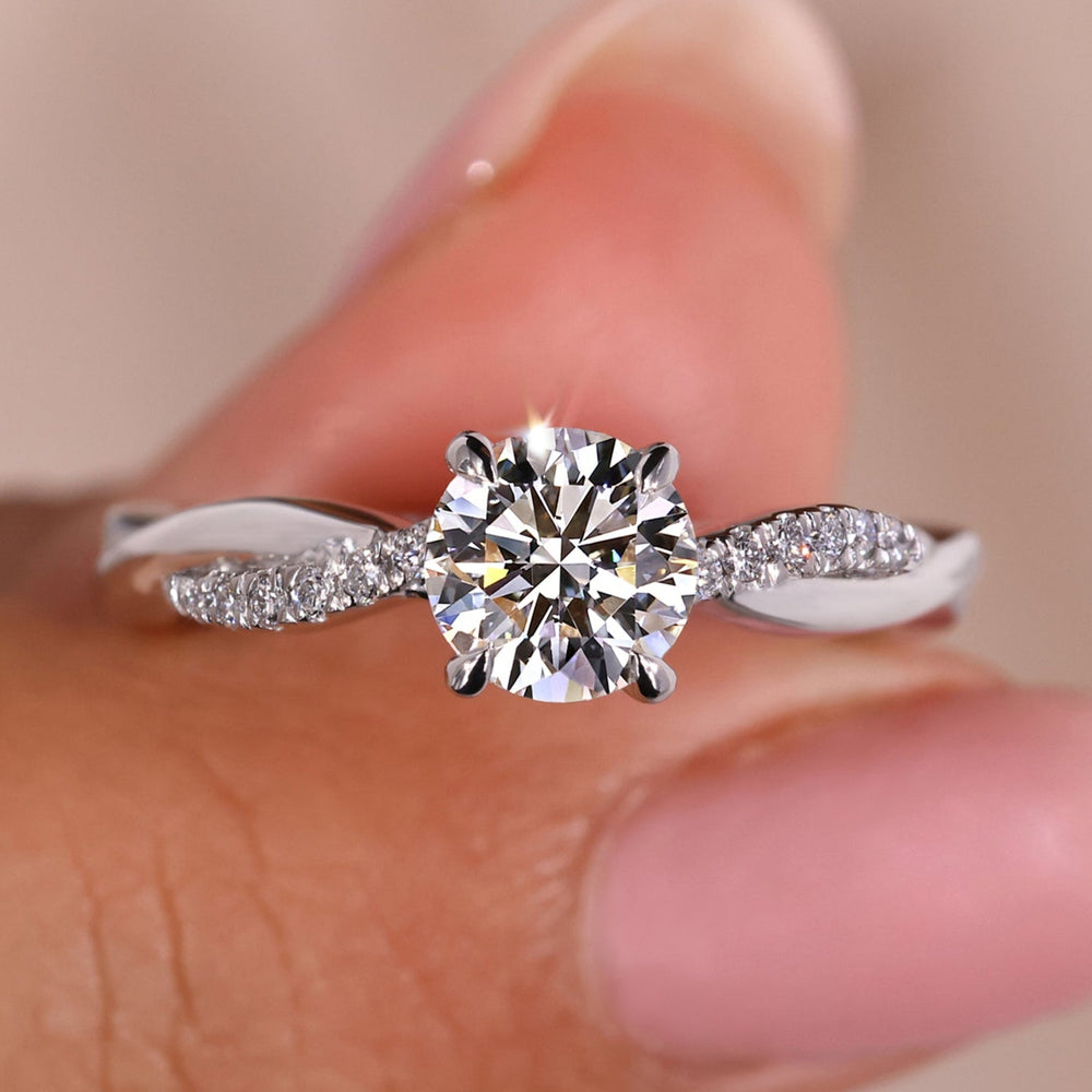Twist engagement ring with a modern design and sparkling diamonds.
