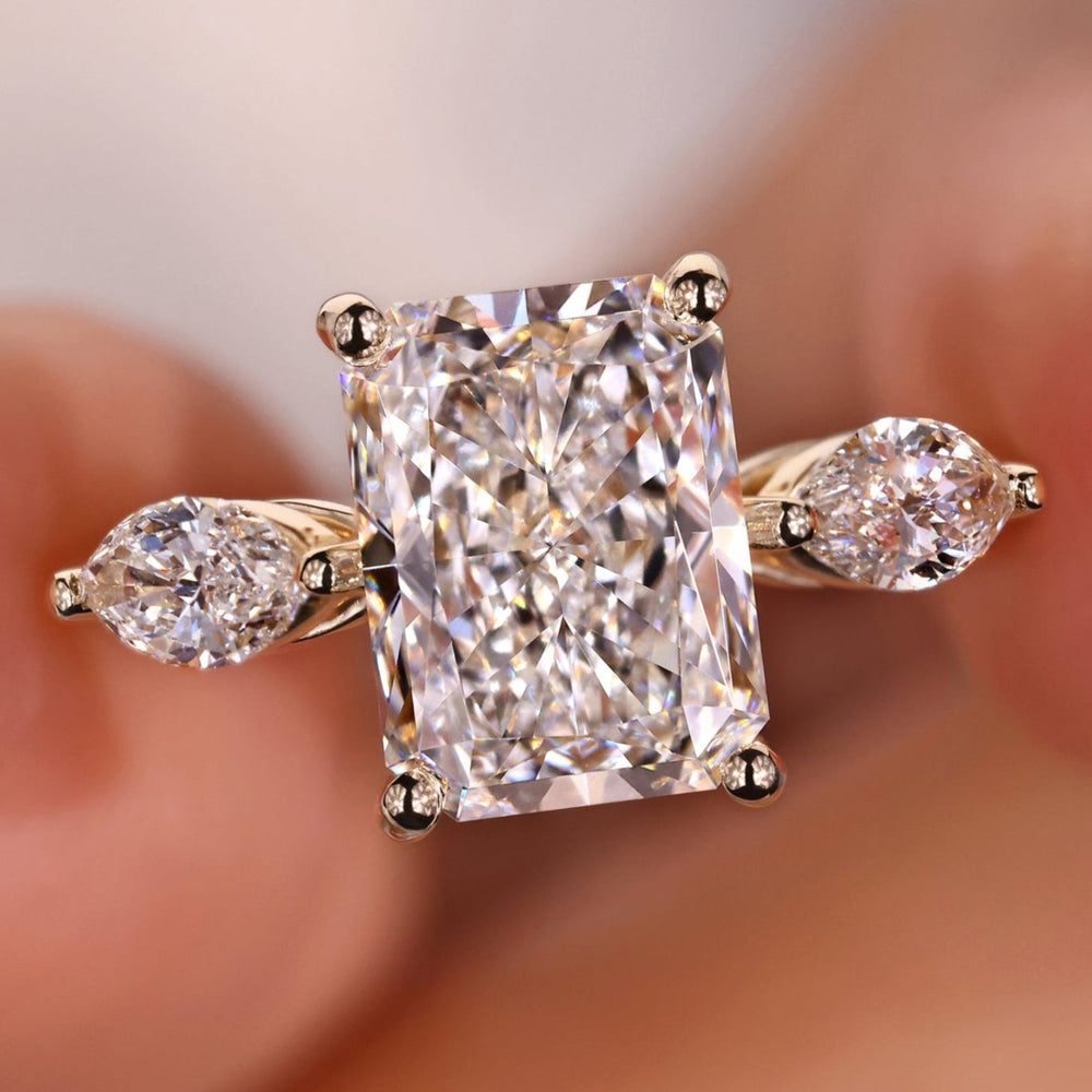 Radiant cut diamond ring with stunning three-stone design.
