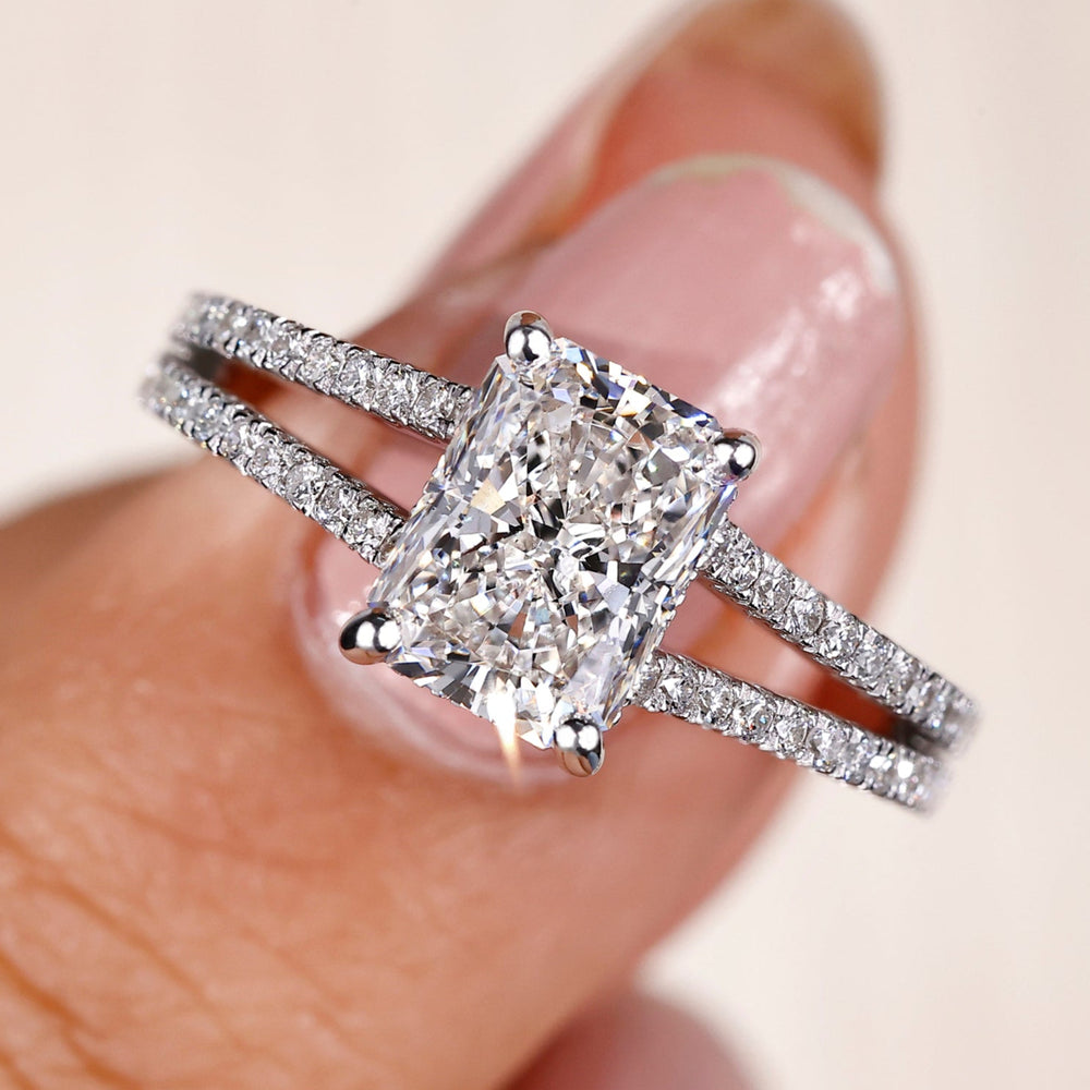 Radiant cut diamond ring with a hidden halo design for a timeless look.
