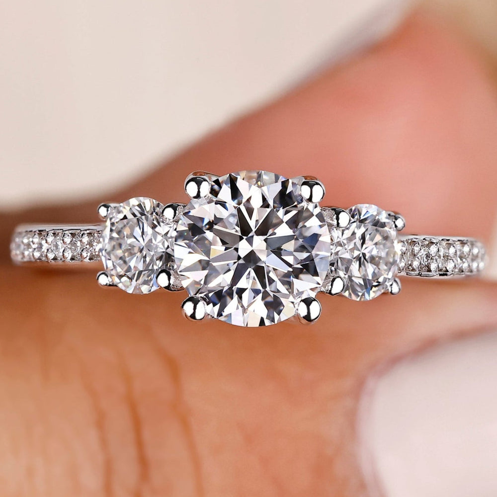 Round cut diamond ring with pave diamond band.
