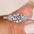 Round cut diamond ring with pave diamond band.
