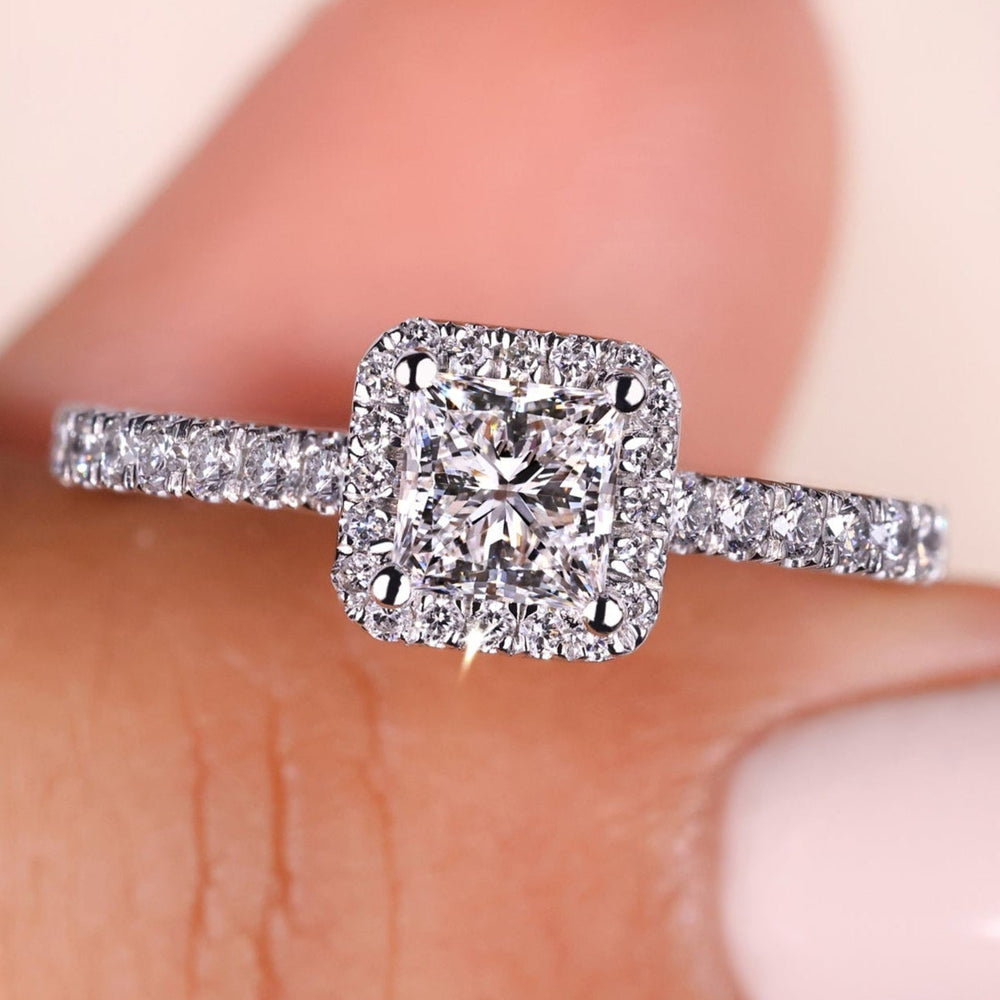 Princess cut halo ring featuring a stunning design with sparkling diamonds, perfect for a timeless and elegant look.
