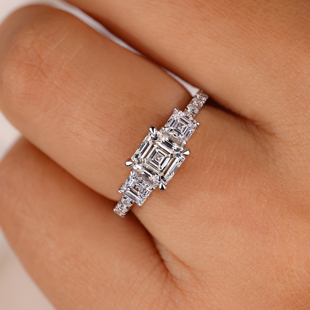 Asscher cut ring with a pave diamond band.
