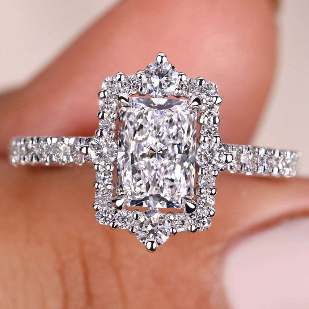 Radiant engagement ring with a halo diamond setting for timeless brilliance.
