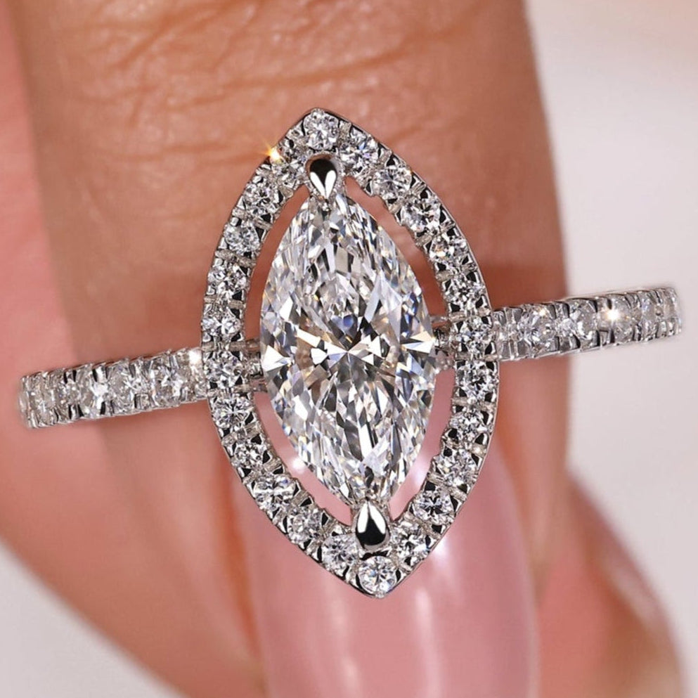 Marquise halo engagement ring with a marquise diamond with halo and pave stones, perfect for timeless elegance.
