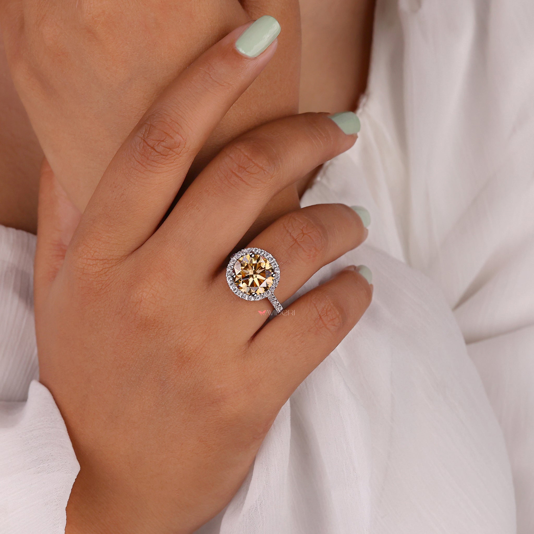 Handmade jewelry featuring a round halo engagement ring.
