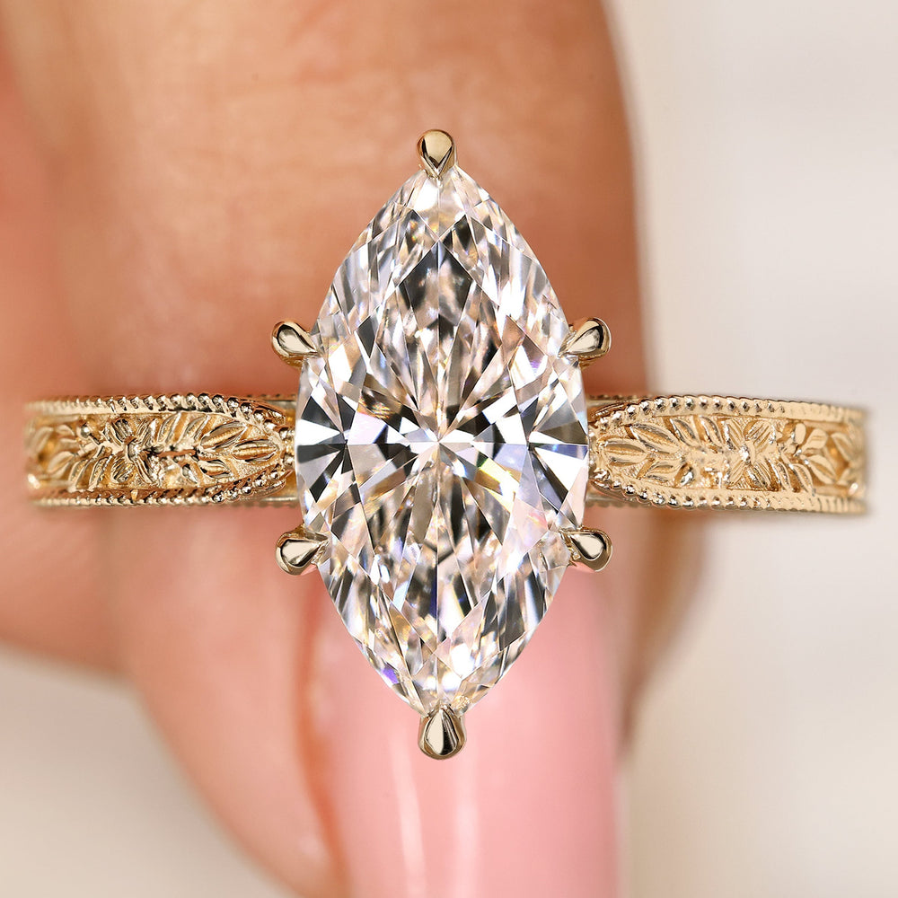 Marquise center lab grown diamond ring with filigree engraving
