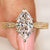 Marquise center lab grown diamond ring with filigree engraving
