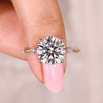 Round cut diamond ring with round side stones.
