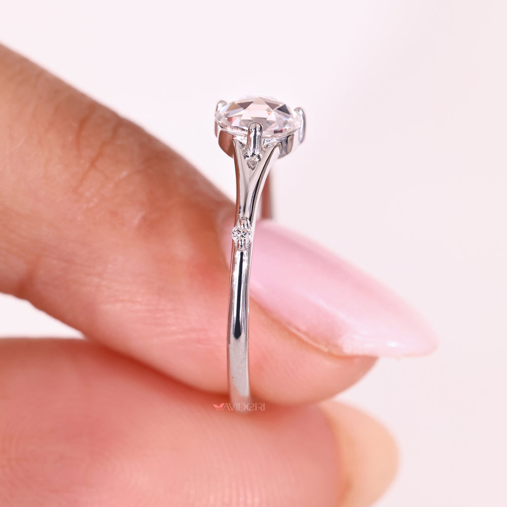 Five stone ring with round side diamonds.
