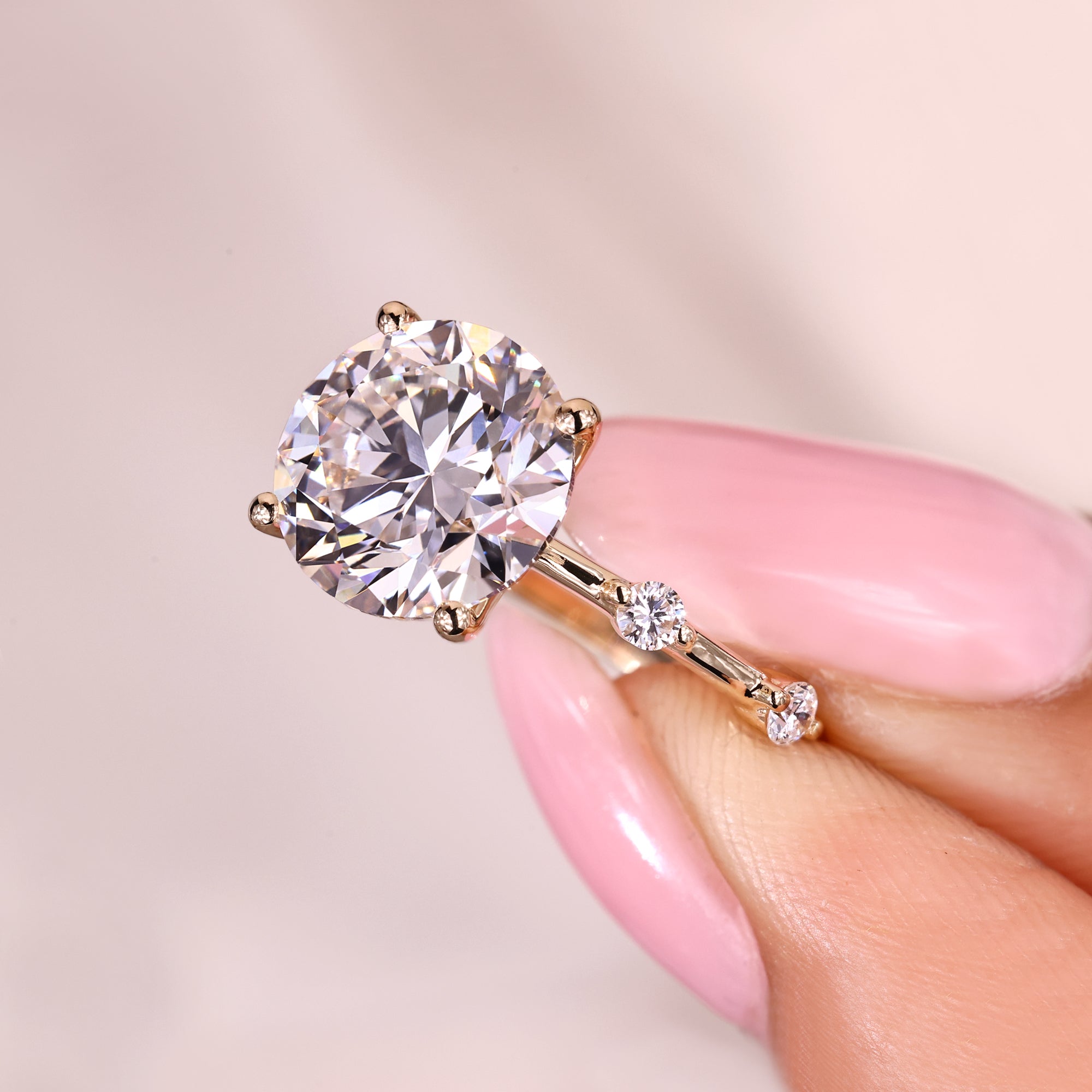 Round diamond ring with spaced pave setting.
