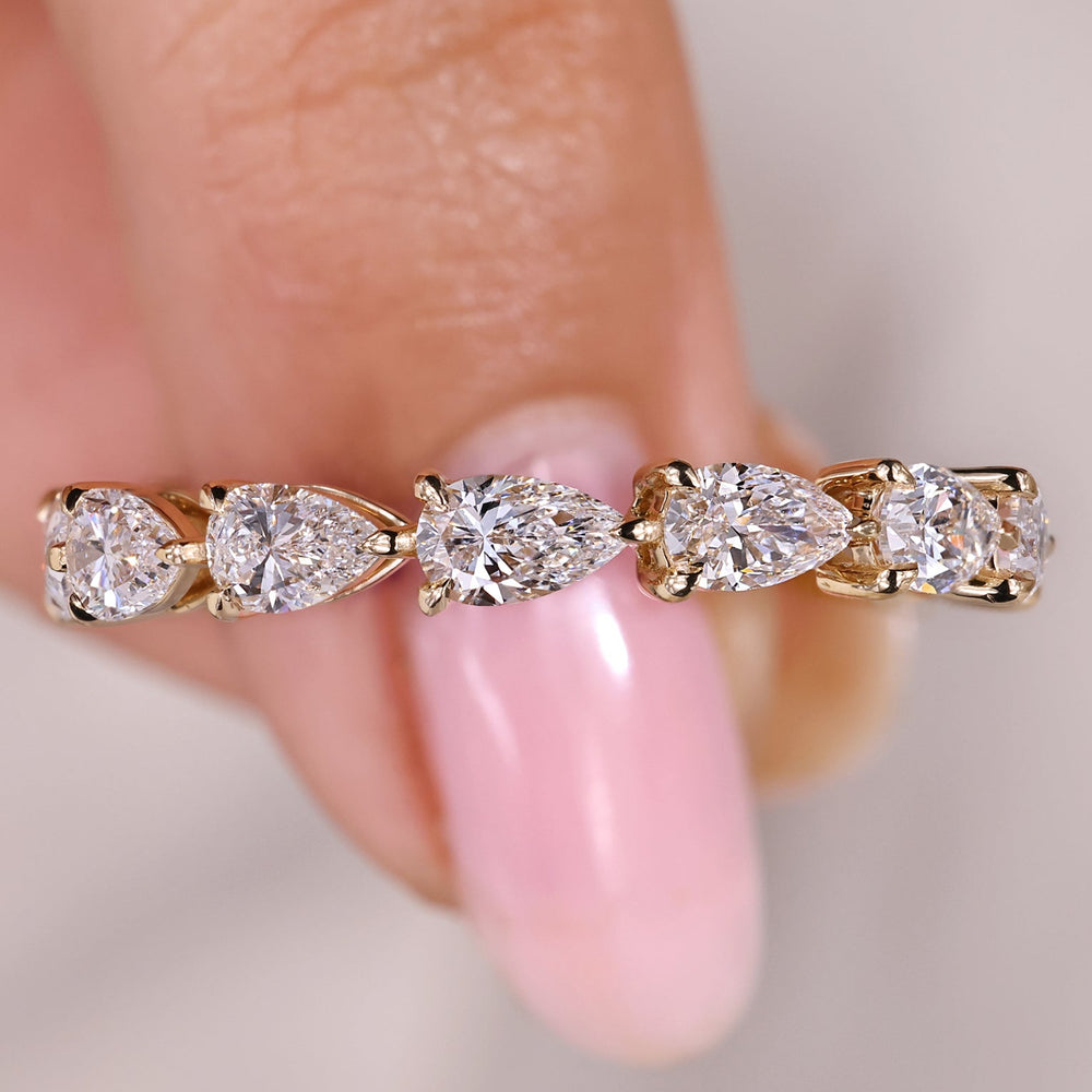Full eternity band with pear cut diamond prong setting.
