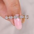 Full eternity band with pear cut diamond prong setting.
