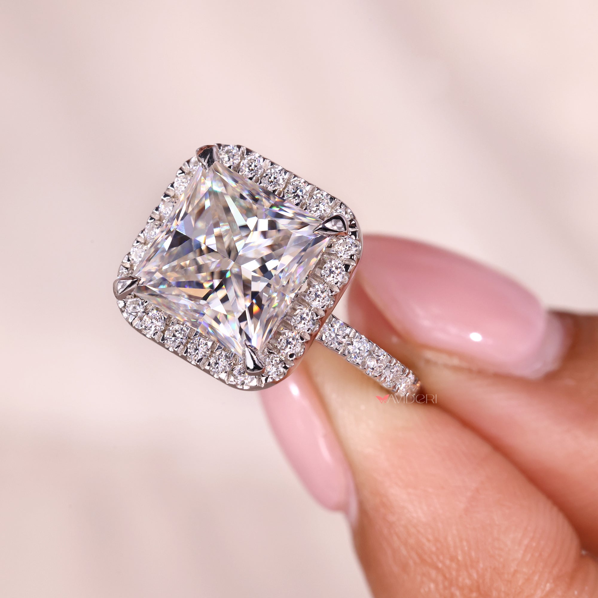 Halo engagement ring on four claw prong.