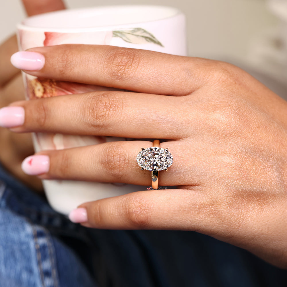 Handmade oval diamond ring with hidden halo style.
