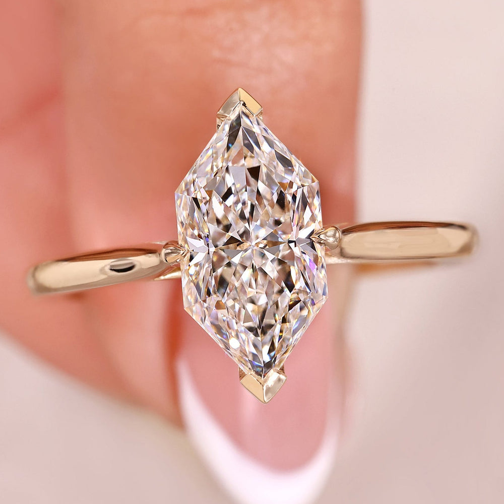 Gold ring with a large diamond on a blurred background