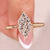 Gold ring with a large diamond on a blurred background