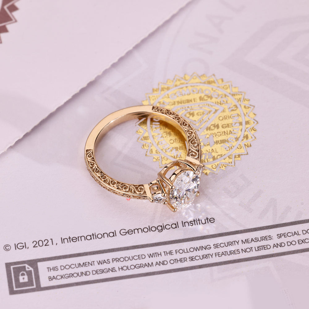Oval diamond ring with round side stones and prongs
