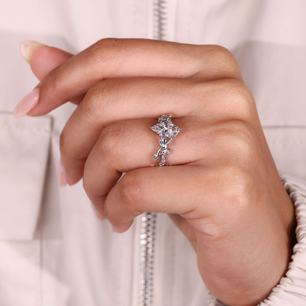 Leaf style marquise diamond ring with nature inspired design.

