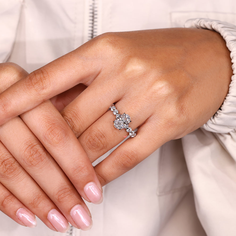 Oval ring with round diamonds and prong setting.
