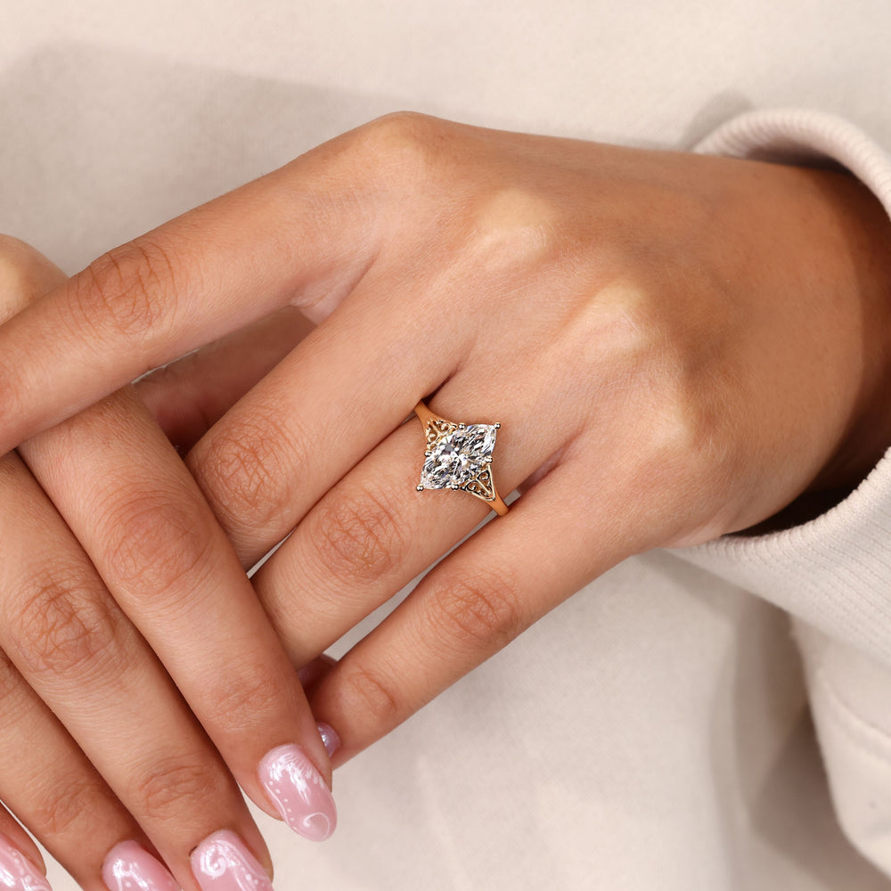 Marquise cut engagement ring with vintage scrollwork.
