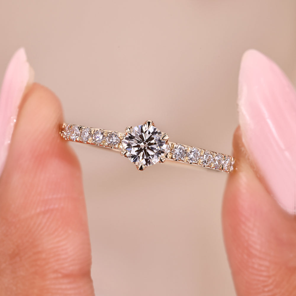 Six claw prong setting ring with yellow gold ring.