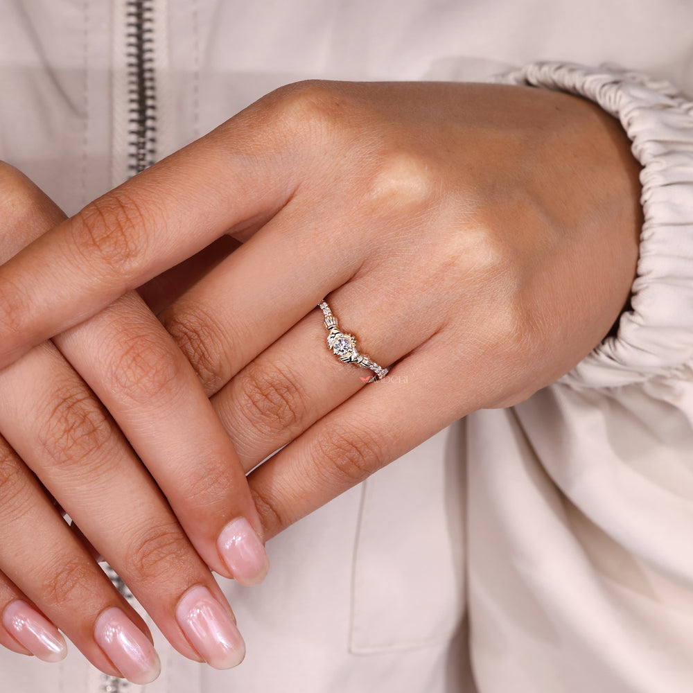Round ring with claddagh and tapered shank.
