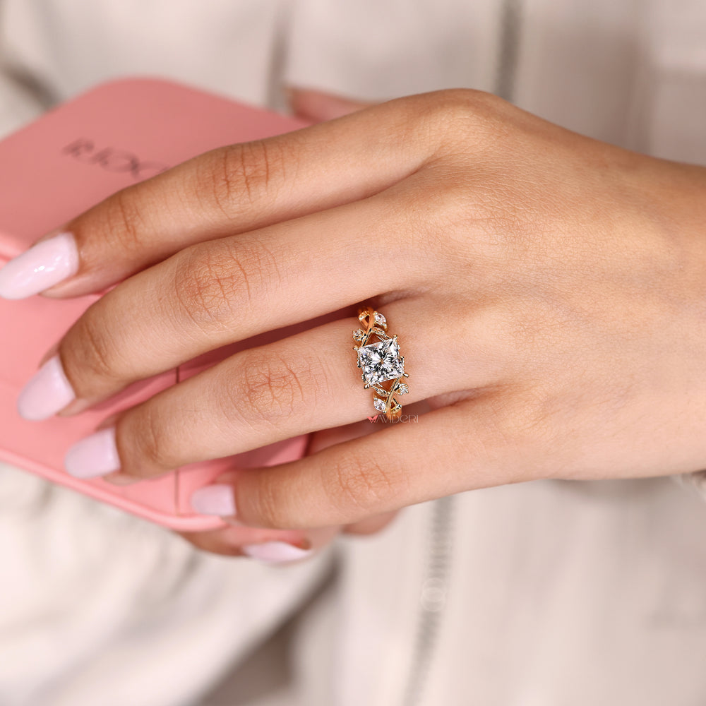 Princess ring with round and marquise side stones.

