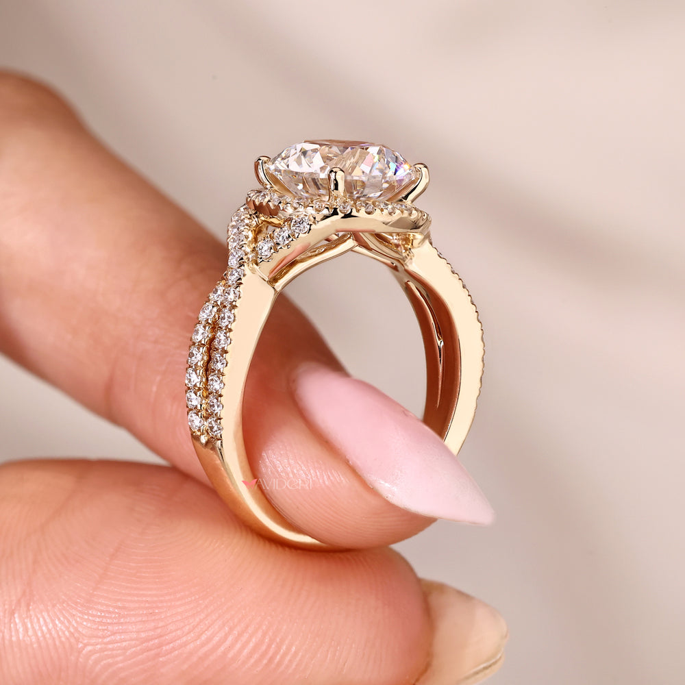 Twisted shank ring with halo style round diamonds.