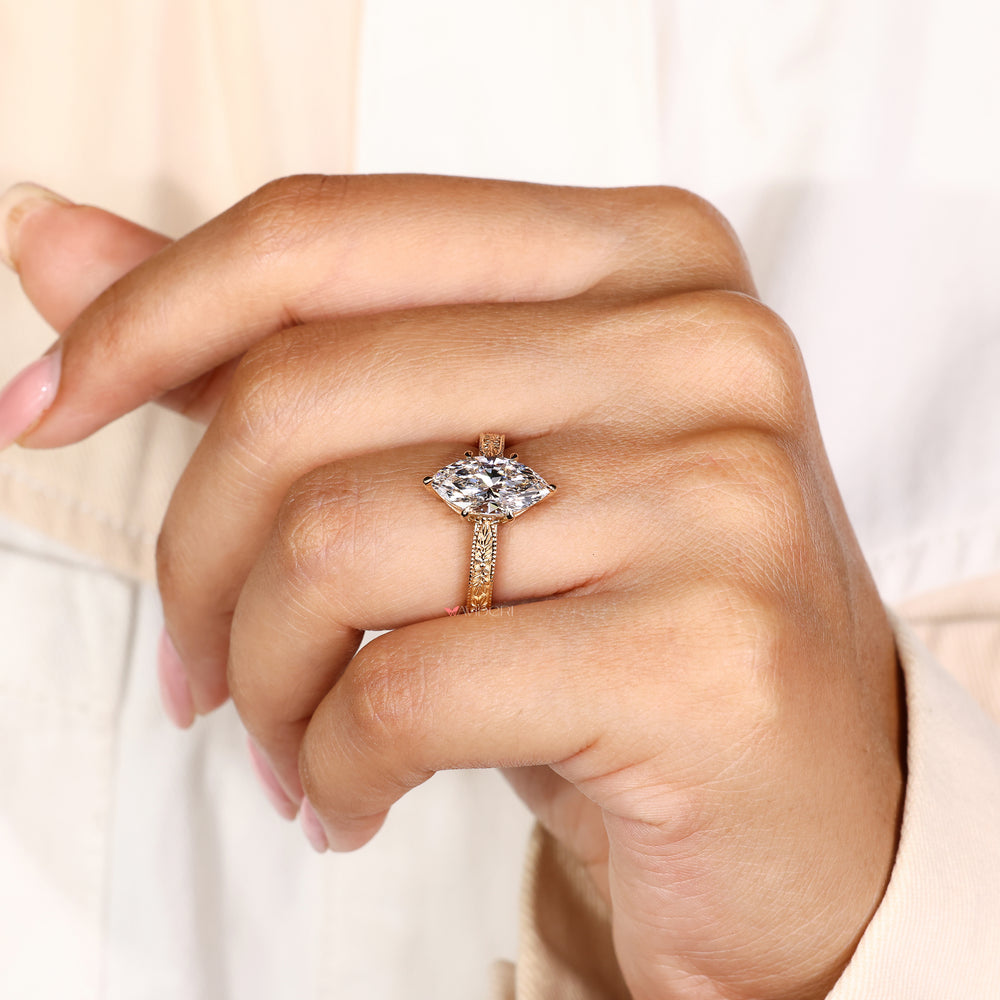 Nature inspired engagement ring with marquise diamond and milgrain
