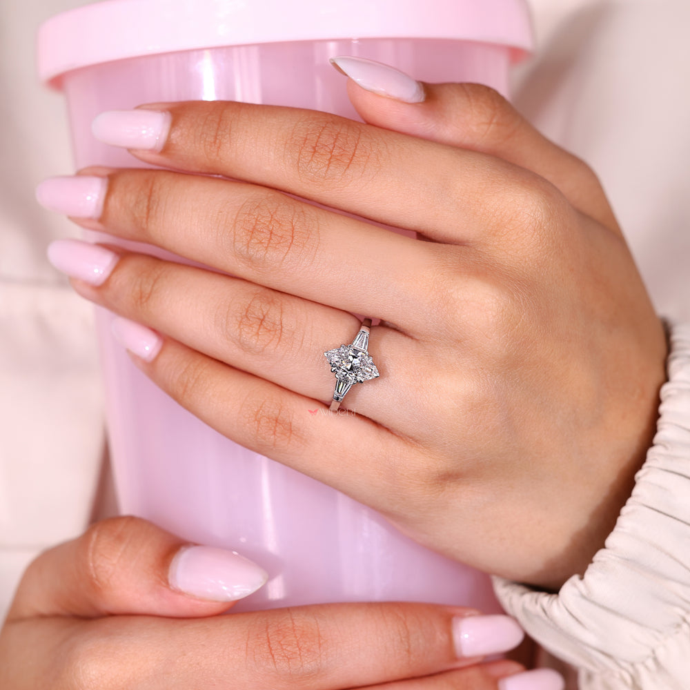 Three stone marquise ring with tapered baguettes.
