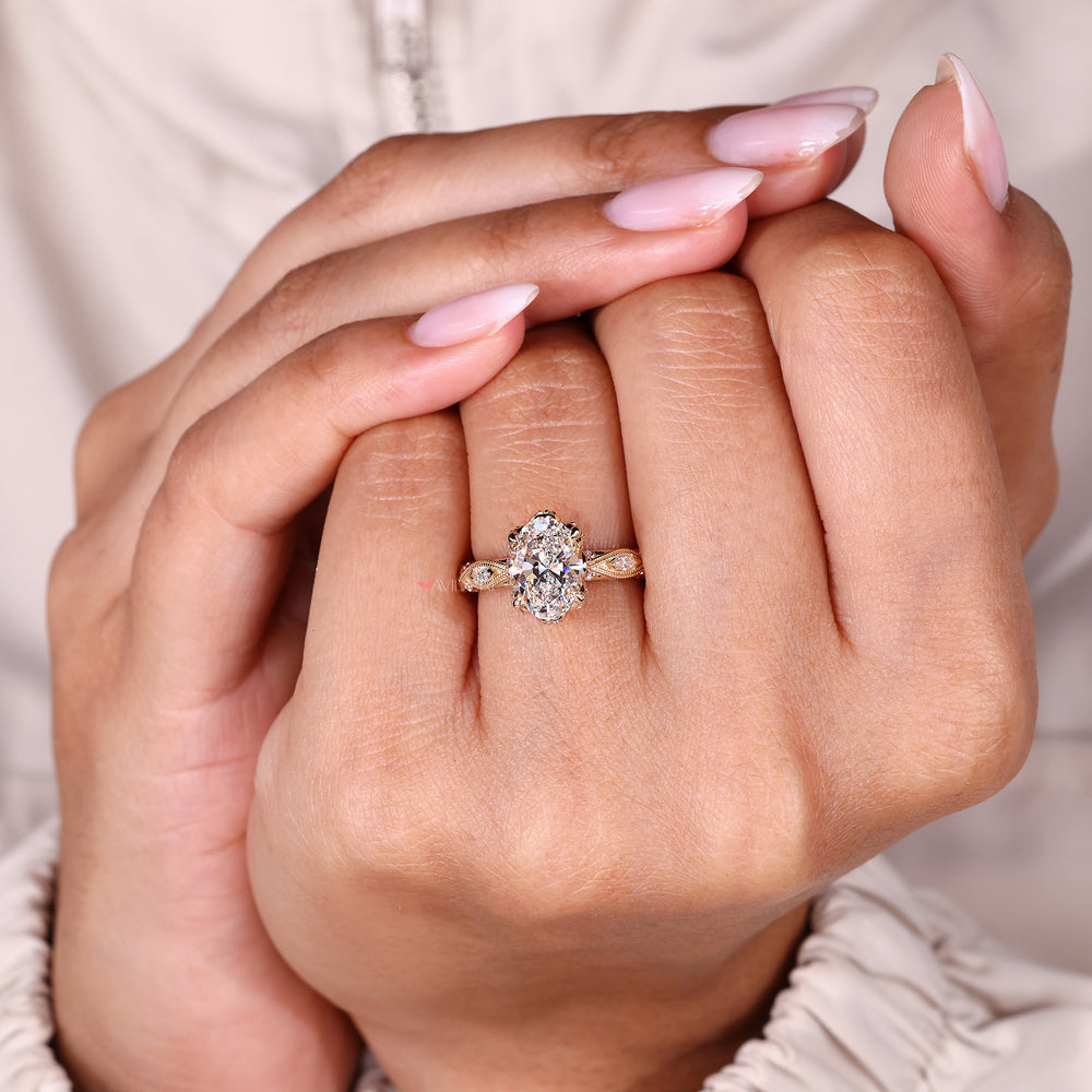 Oval cut ring with round diamond accents.
