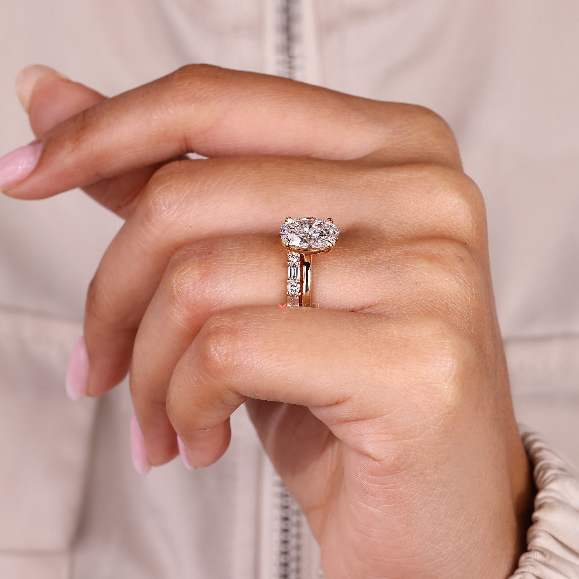 Half eternity oval diamond ring with round and emerald stones.