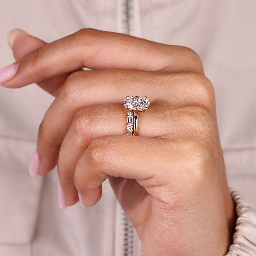 Half eternity oval diamond ring with round and emerald stones.