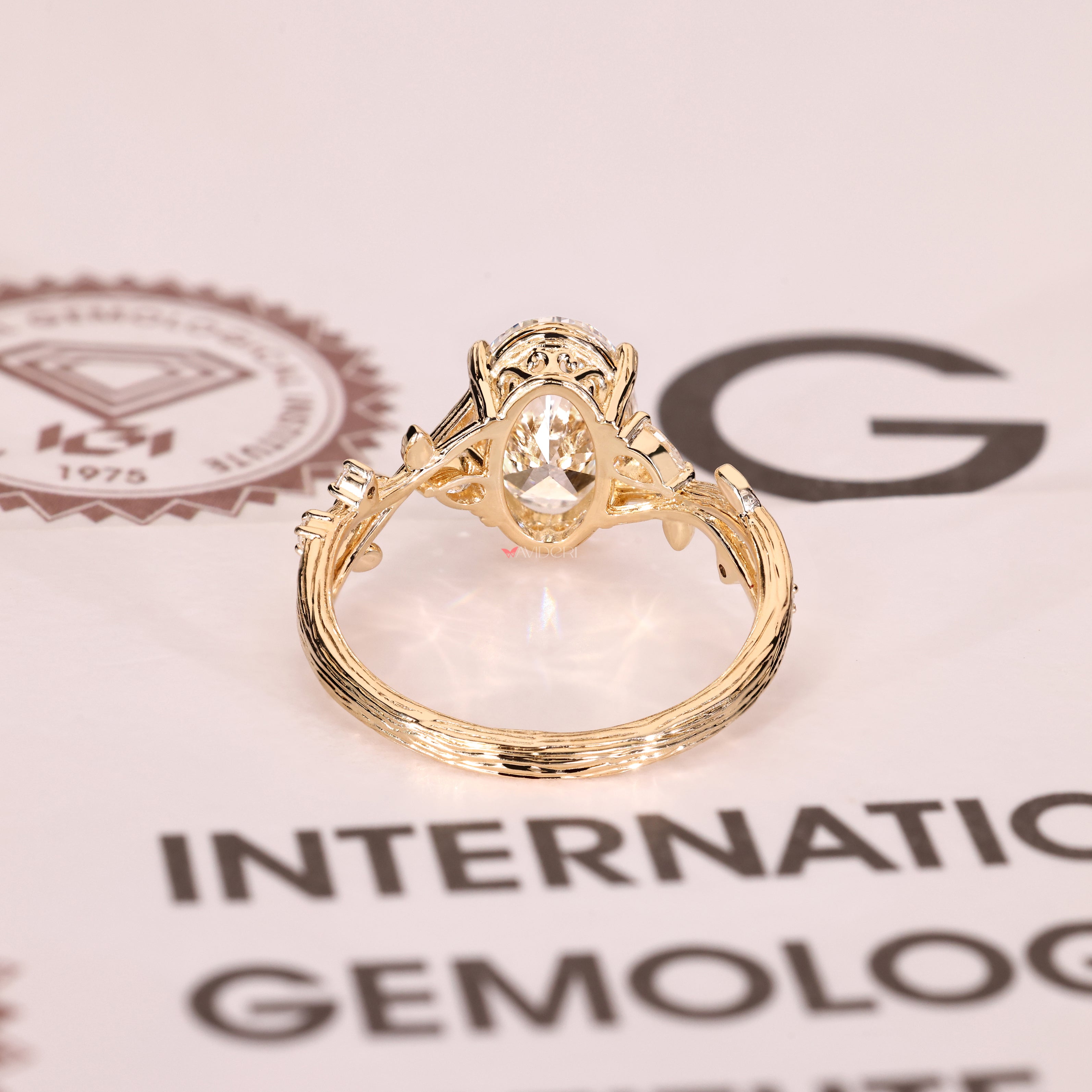 Art deco diamond ring with pear and round accents
