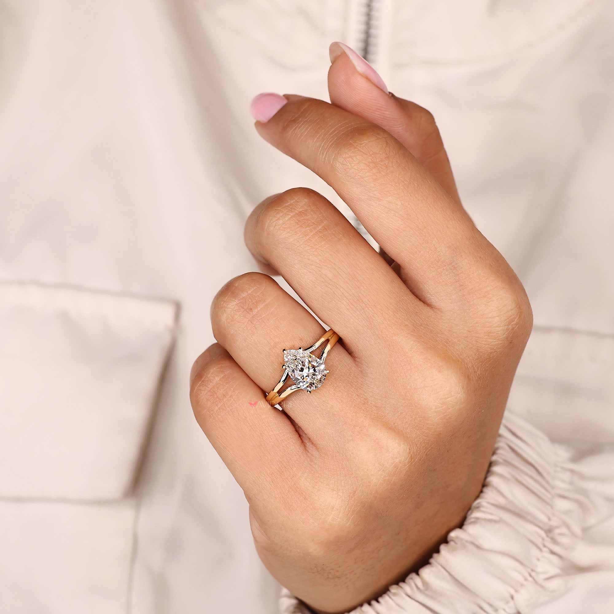 Pear cut lab grown diamond ring featuring five claw prongs.