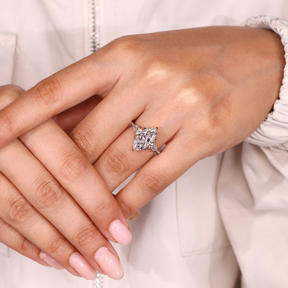 IGI certified marquise ring with kite side stone accents.
