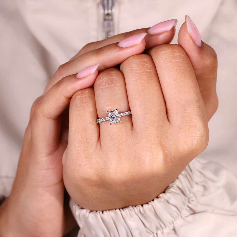 Radiant cut diamond ring with elegant pave band.