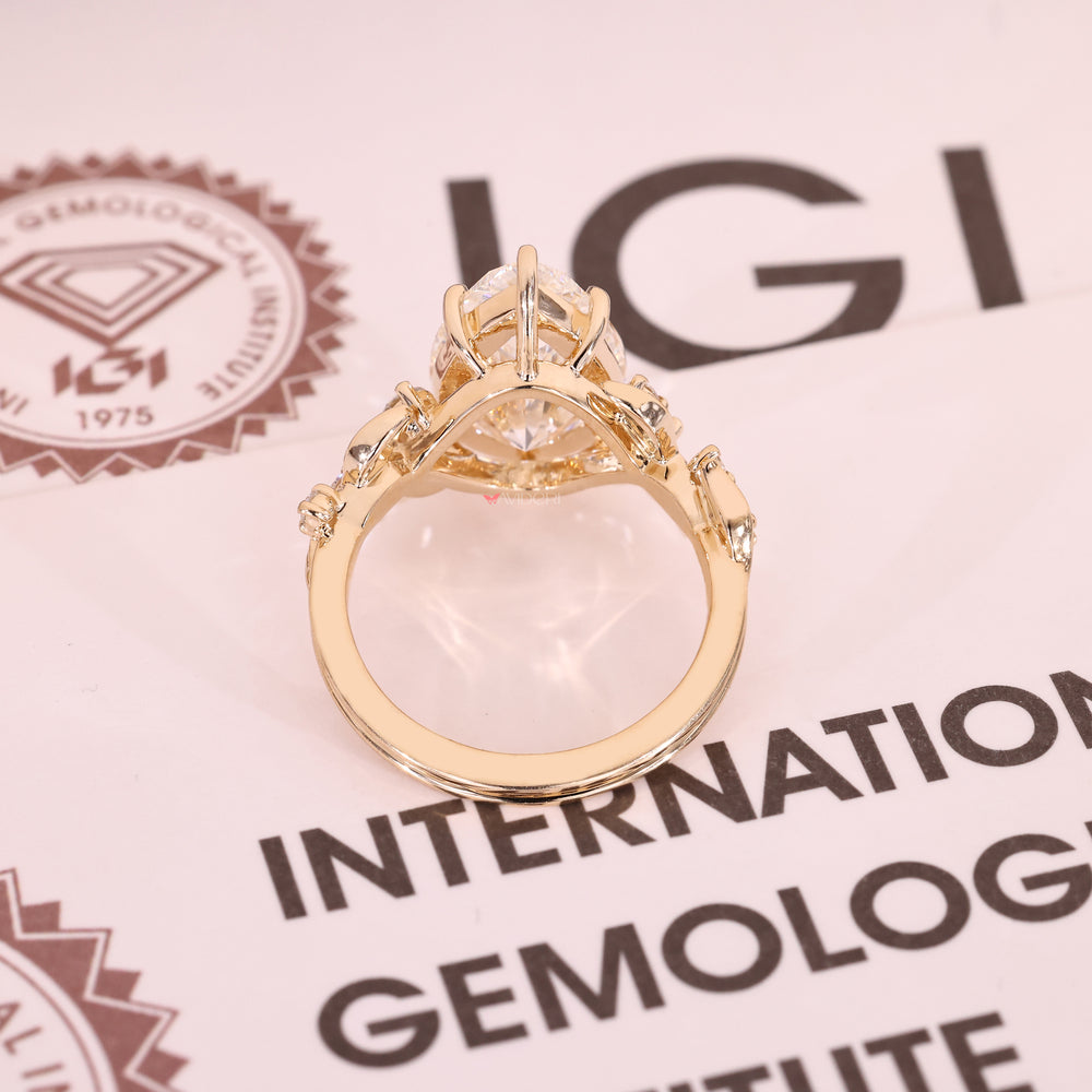 IGI certified pear cut diamond ring with cluster setting.
