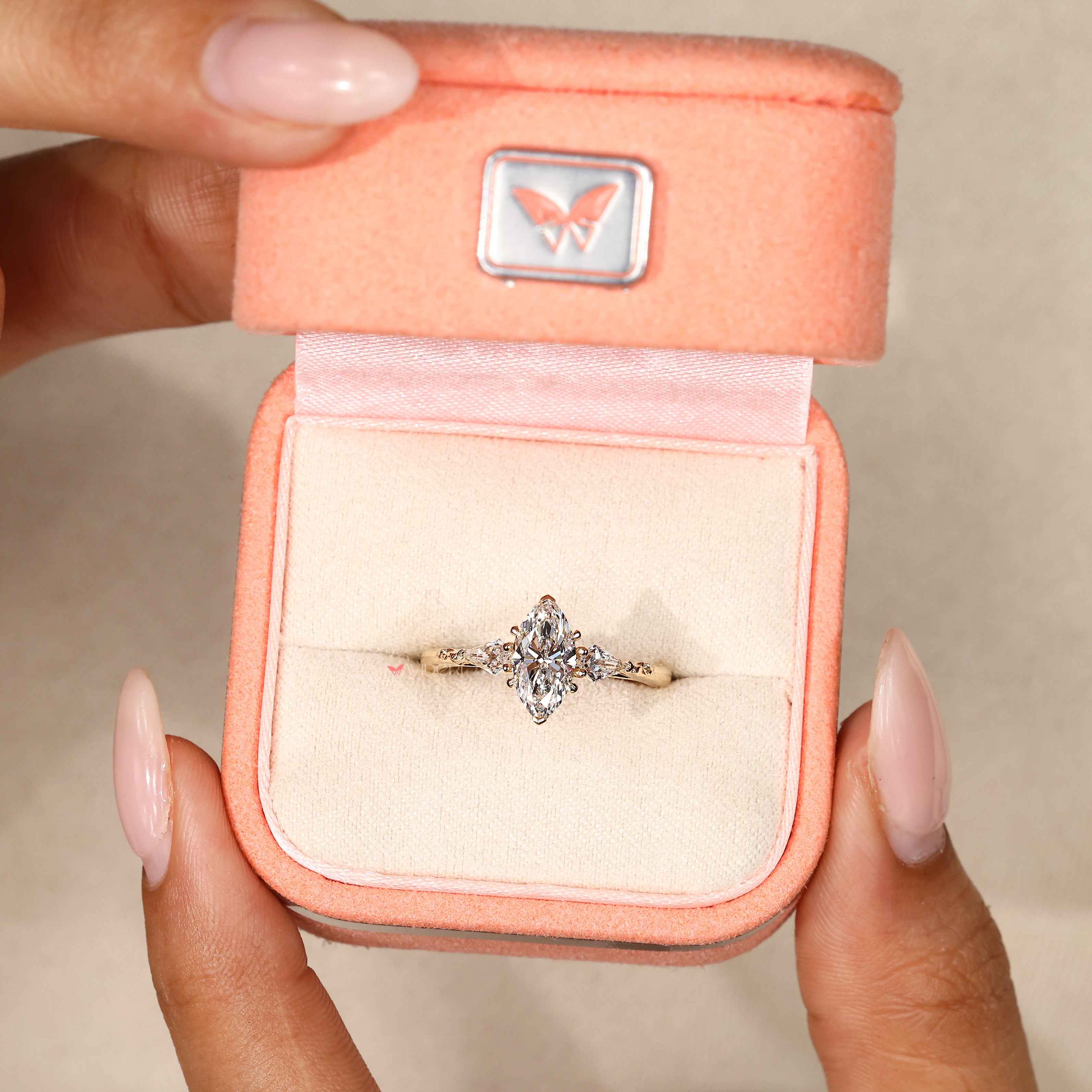 Kite side stone marquise diamond engagement ring.
