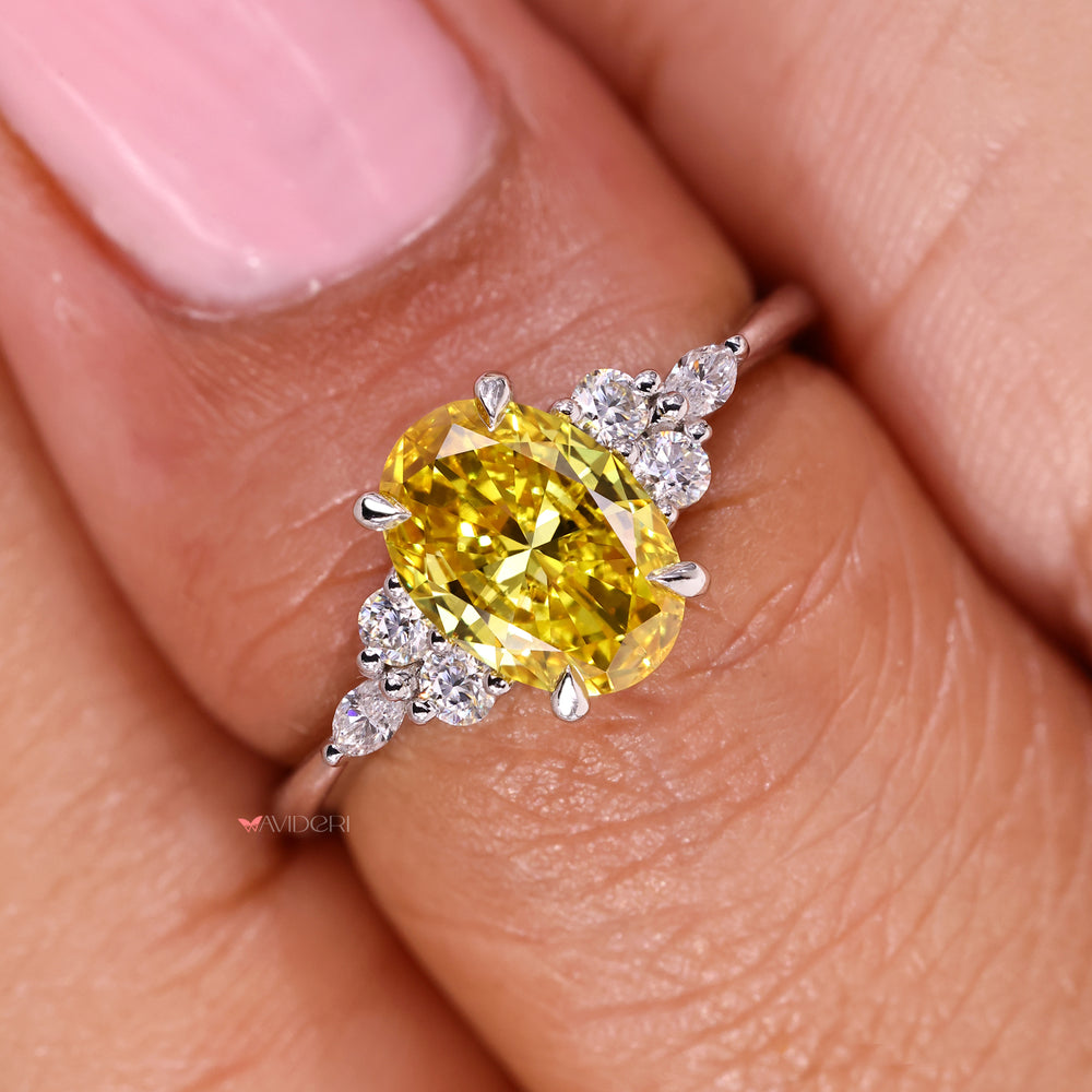 Elegant oval yellow diamond ring in muse setting.