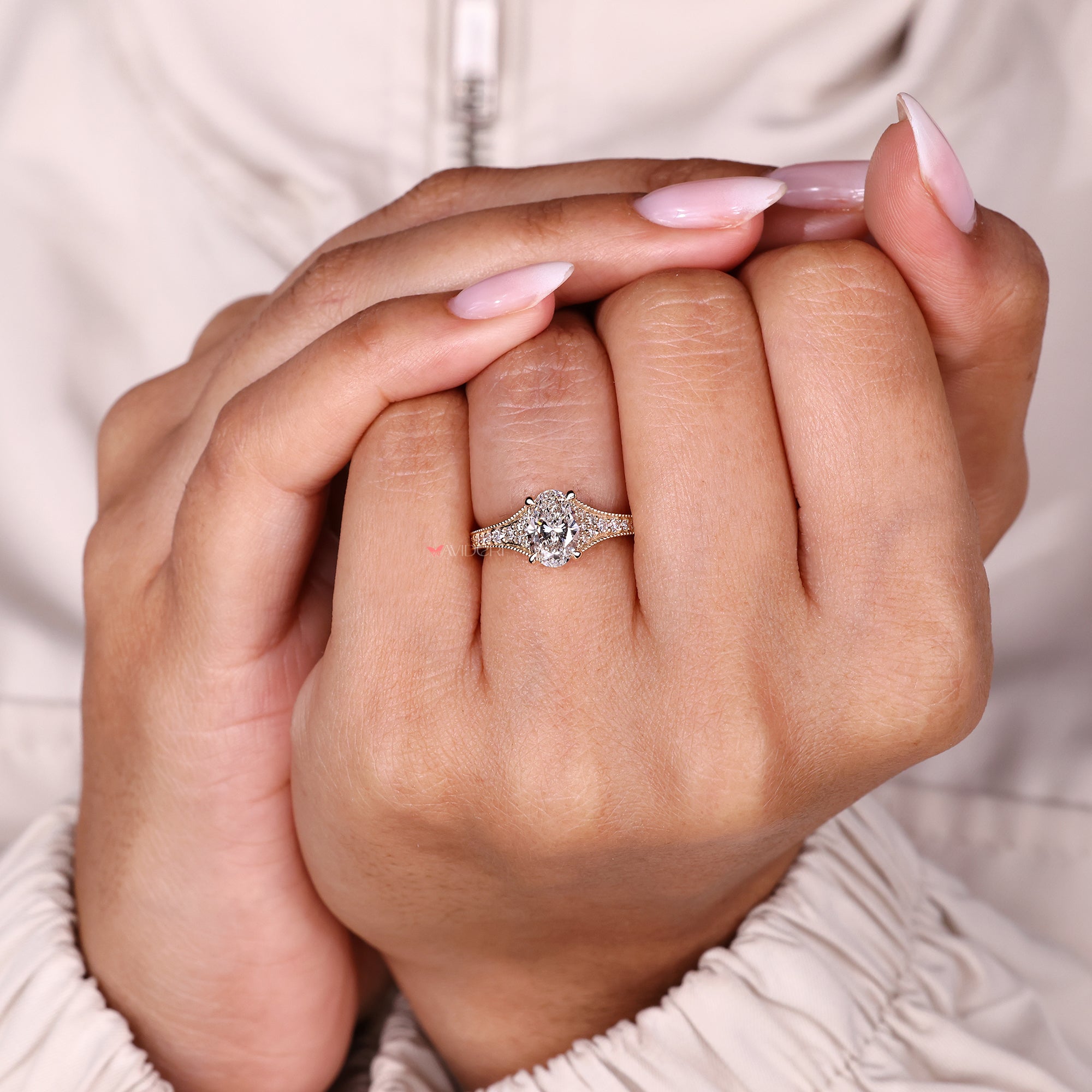 Oval cut ring with round diamond accents.
