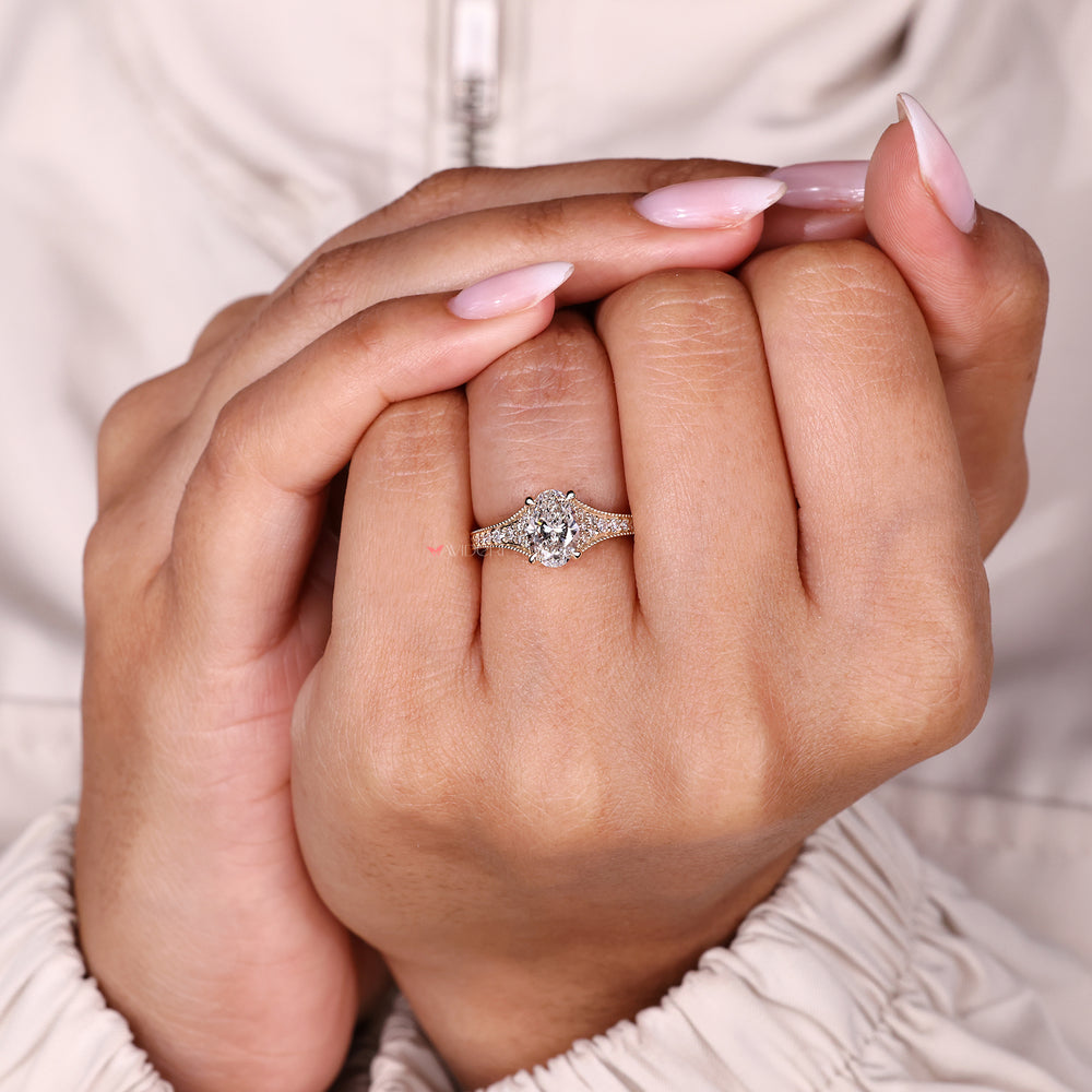 Oval cut ring with round diamond accents.
