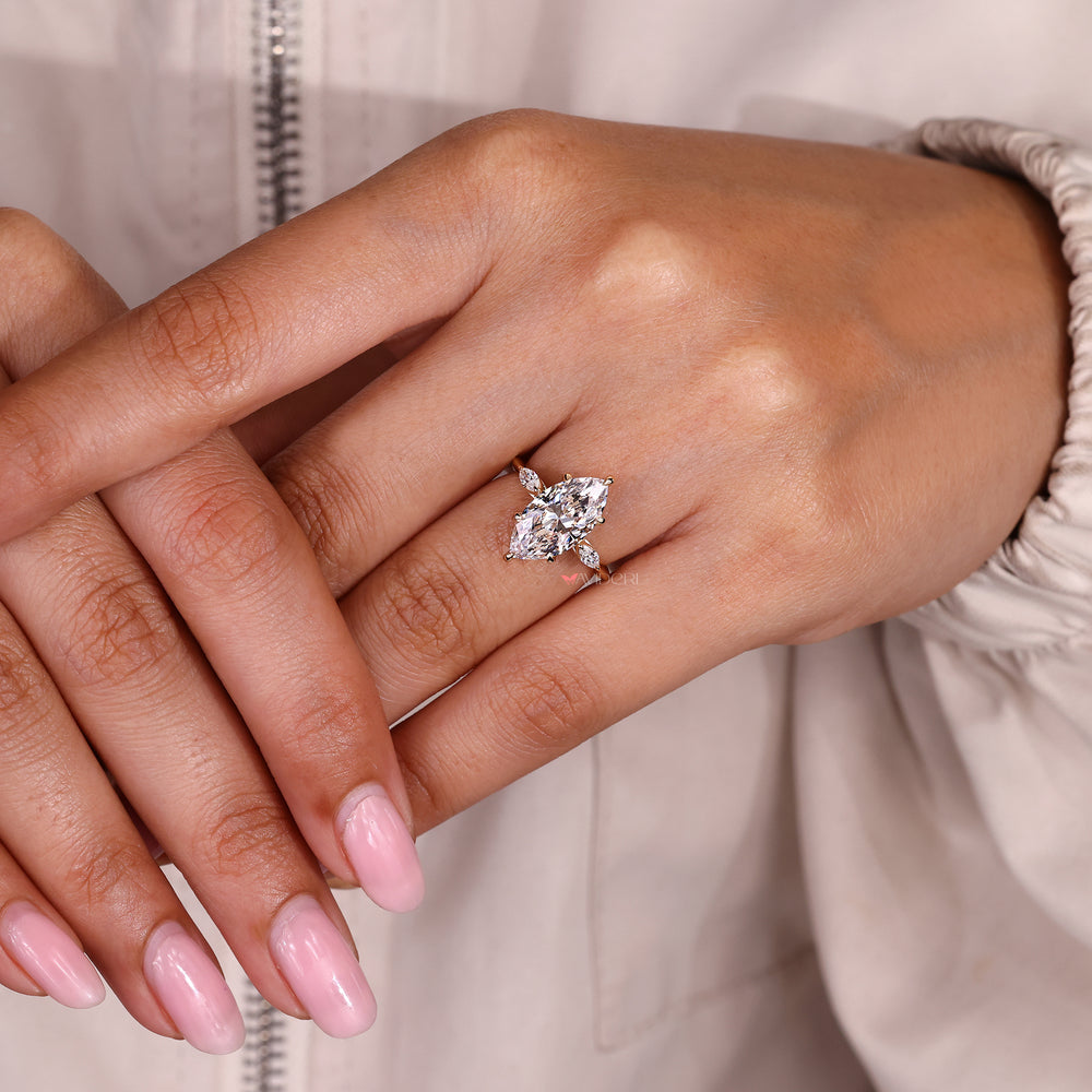 Three stone diamond ring featuring knife edge shank design.
