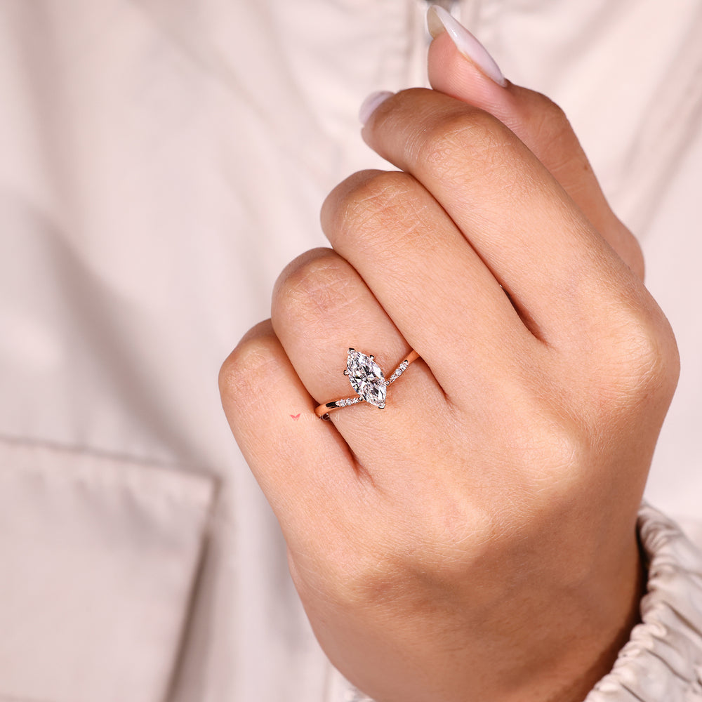 Marquise diamond ring with sparkling pave style.
