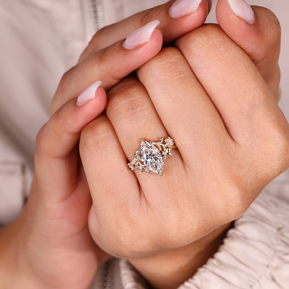 Marquise diamond ring with round diamond accents.
