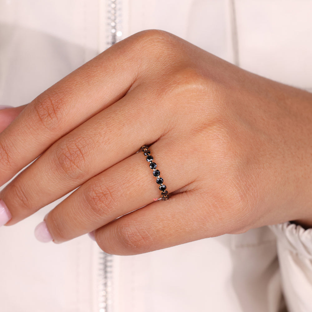 A black moissanite wedding band adds bold contrast and style.