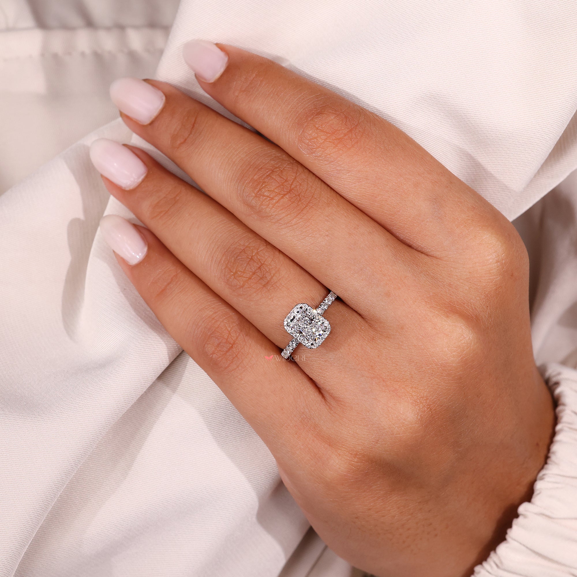 Prong set radiant engagement ring with lab grown diamond.