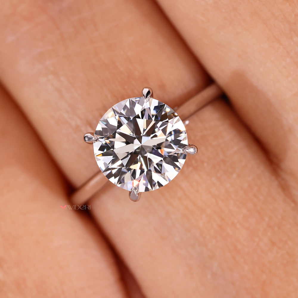 Four claw prong set round diamond ring with tapered band.
