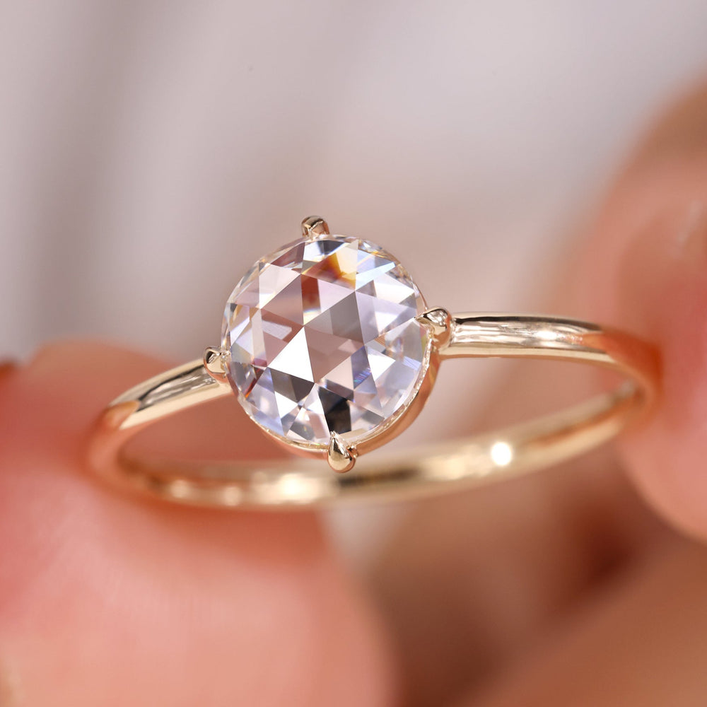 Round rose cut diamond ring with a delicate solitaire setting.
